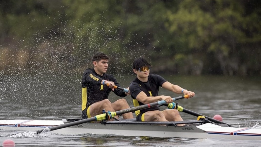 Two-person pair boat gliding across flat water